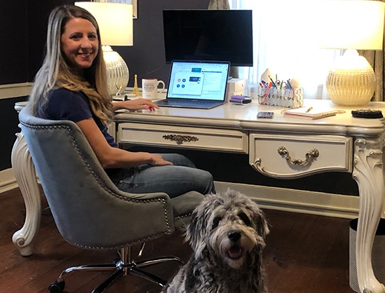 Promet Source PMO working remotely with her dog, Lumen, by her side