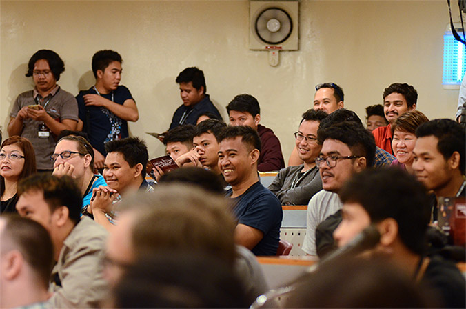 Image of attendees in a session room.