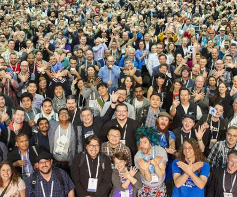 Hundreds of DrupalCon attendees posing for a photo.