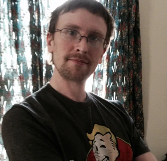 Josh looking at the camera with arms crossed